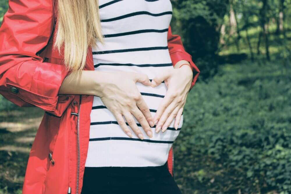 A pregnant woman in a park