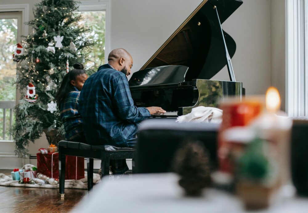 two people playing a piano