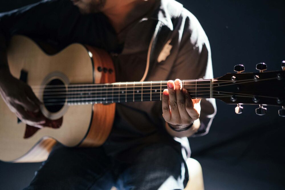 person playing an acoustic guitar