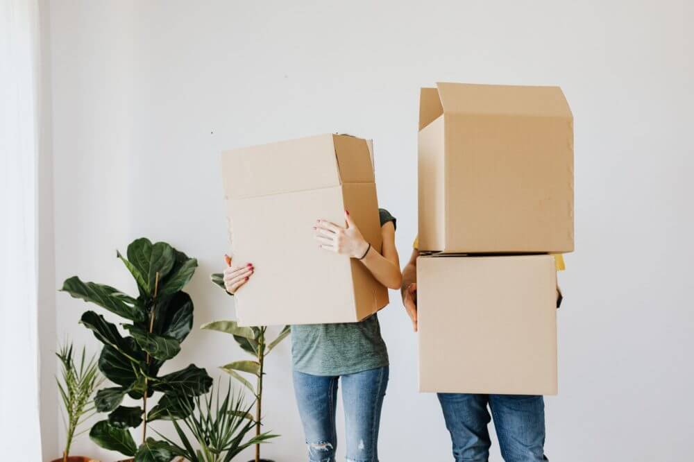 A couple with boxes in their hands during long-distance moving