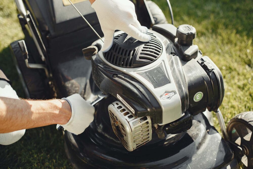 Person checking a lawn mover