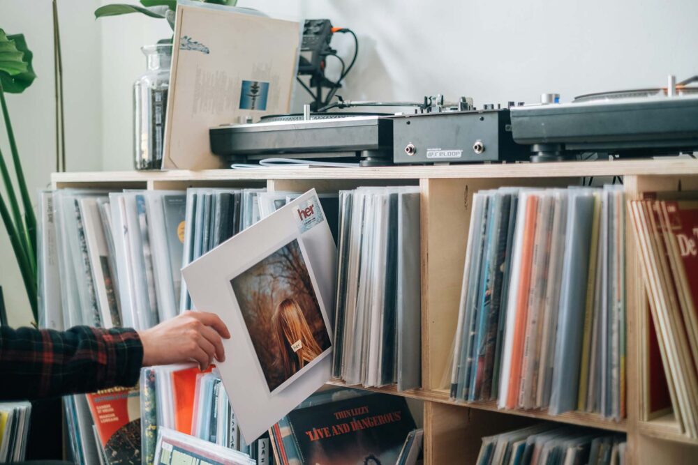 A person taking out one vinyl from their collection