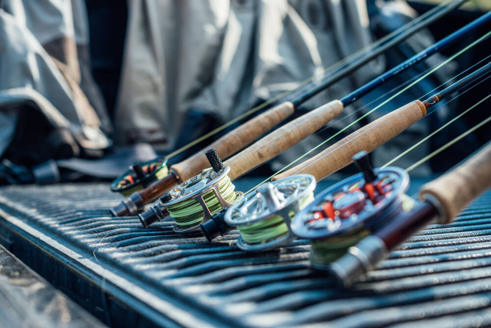 Various fishing rods stacked side by side 