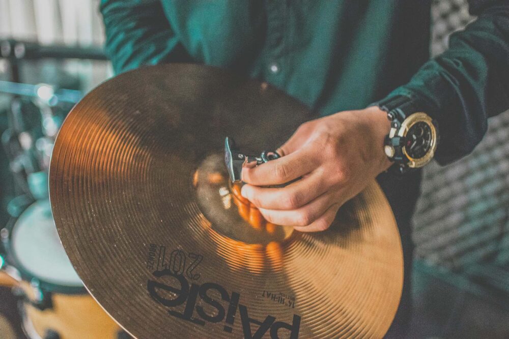 A person holding a cymbal